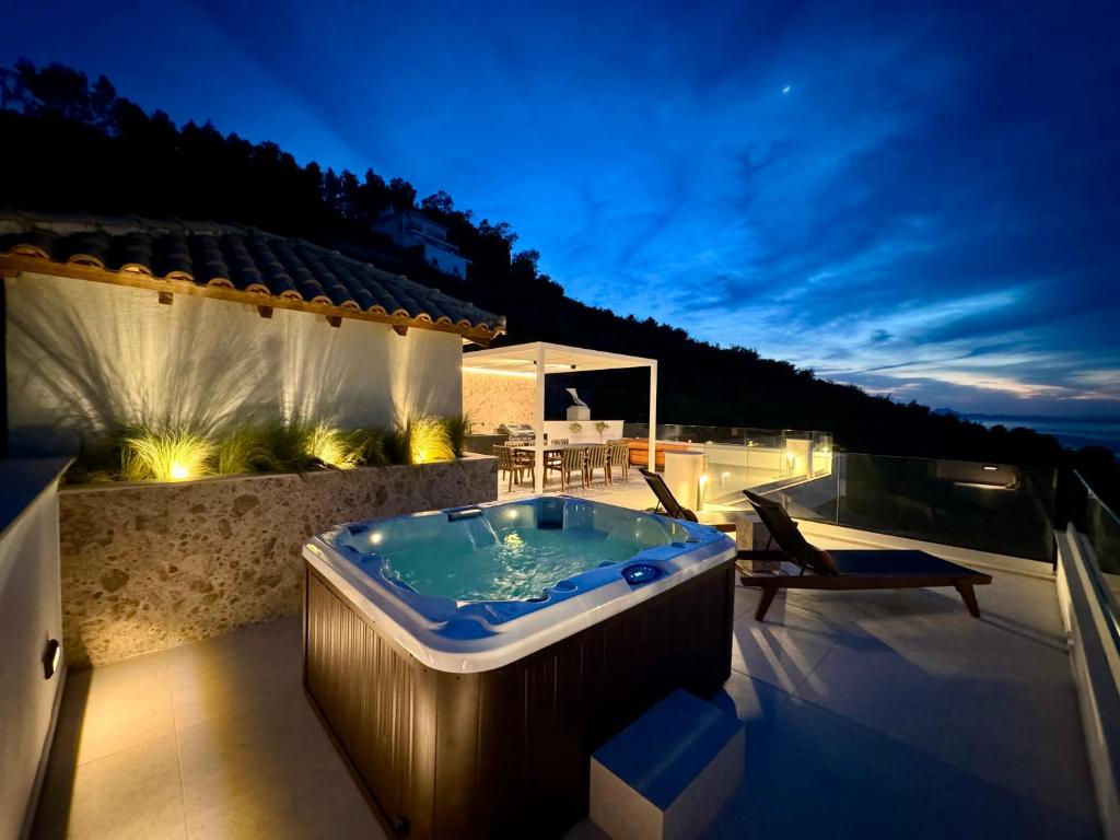 a jacuzzi tub on the roof of a house at Ionion exclusive villa in Syvota