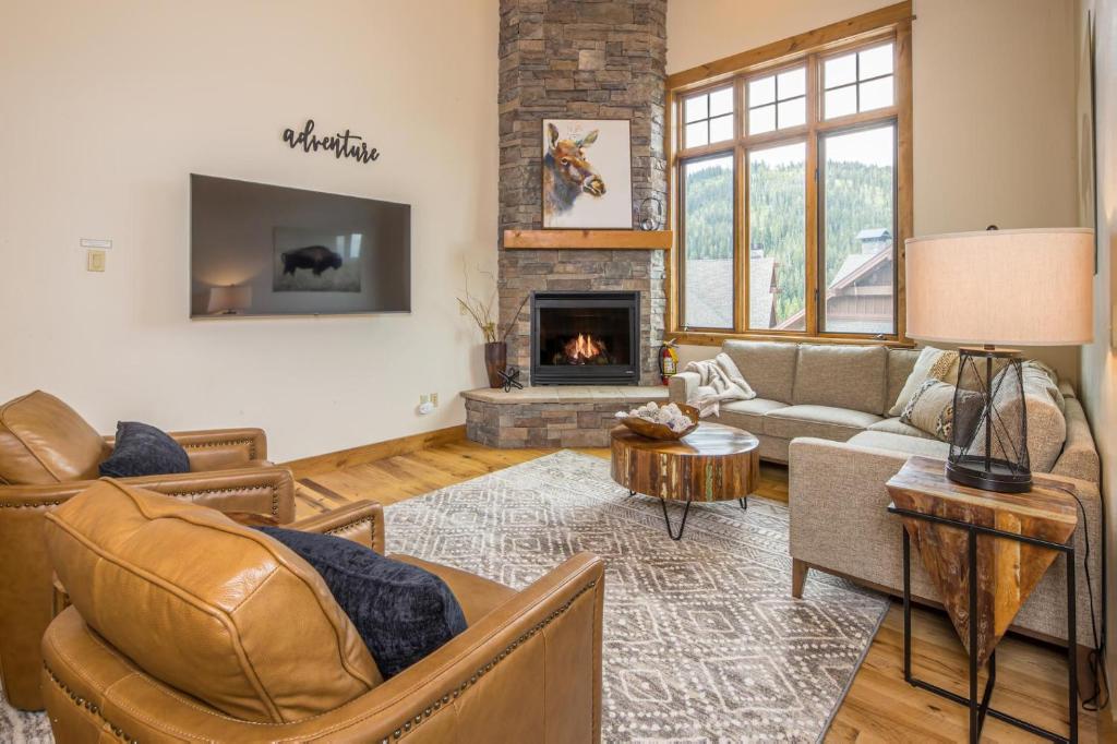 a living room with a couch and a fireplace at Alpenglow Condo 36A in Big Sky