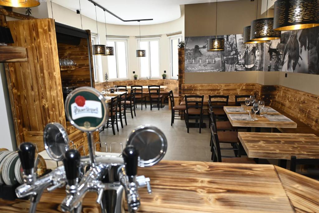 a dining room with wooden tables and chairs at Vila Victory polopenze v Krušných horách in Abertamy