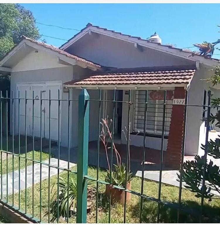 a fence in front of a house at Nafaro in Villa Gesell