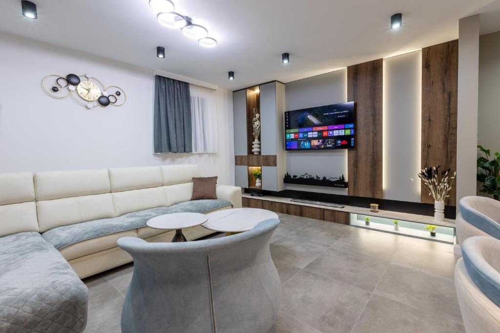 a living room with a couch and a tv at Golden peak Blidinje in Blidinje
