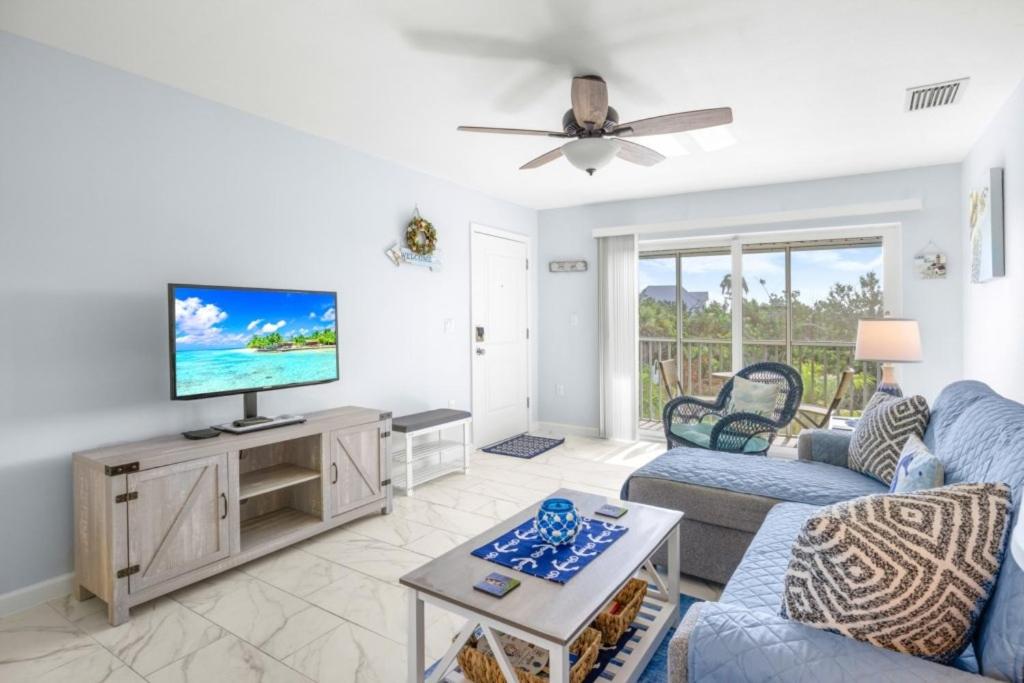 a living room with a tv and a couch at Seashells Unit 44 in Sanibel