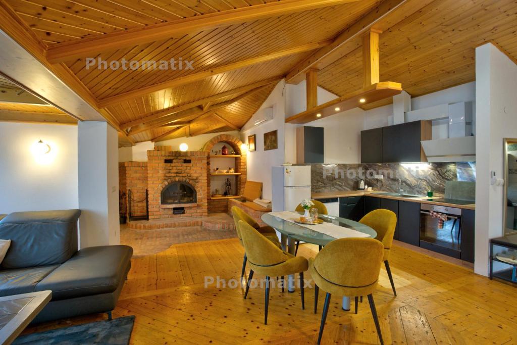 a kitchen and living room with a table and chairs at Rustica Apartments in Maribor