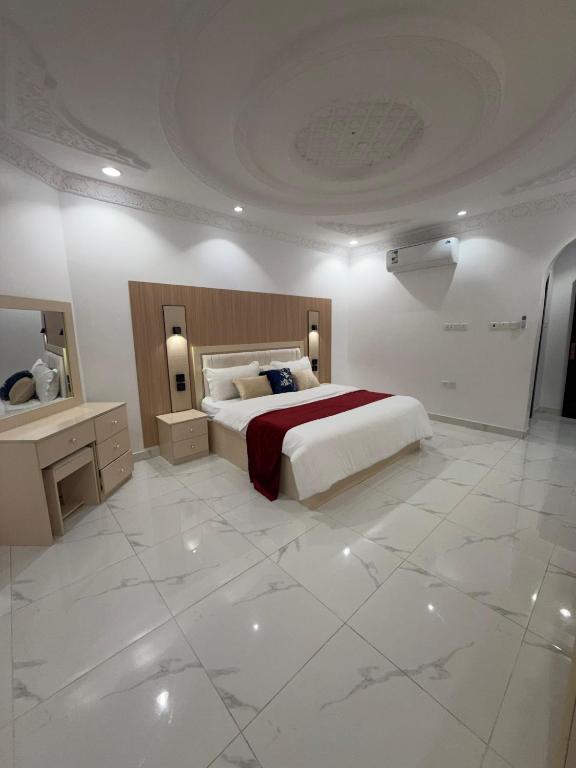 a bedroom with a large bed and a large tile floor at النبلاء الفضي in Medina