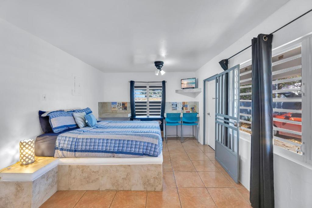 a bedroom with a bed and a walk in closet at Charming Studio by Sandy Beach - Affordable & Private in Rincon