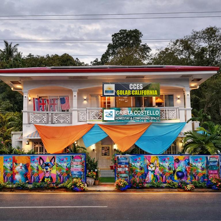a building with a sign in front of it at Crieta Costello Homestay in San Juan
