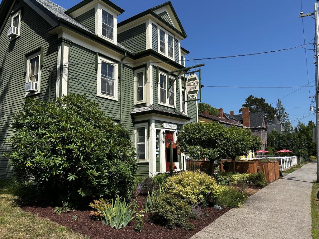 a green house with a sidewalk in front of it at Garrison House Inn in Annapolis Royal