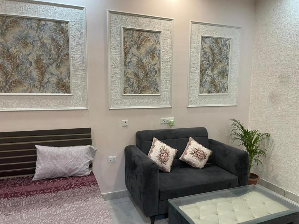 a living room with a couch and a coffee table at StayVerse74 in Noida