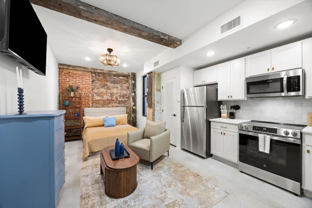 a kitchen and living room with a couch and a table at Park Hotel Studio Suite 203 in Chattanooga