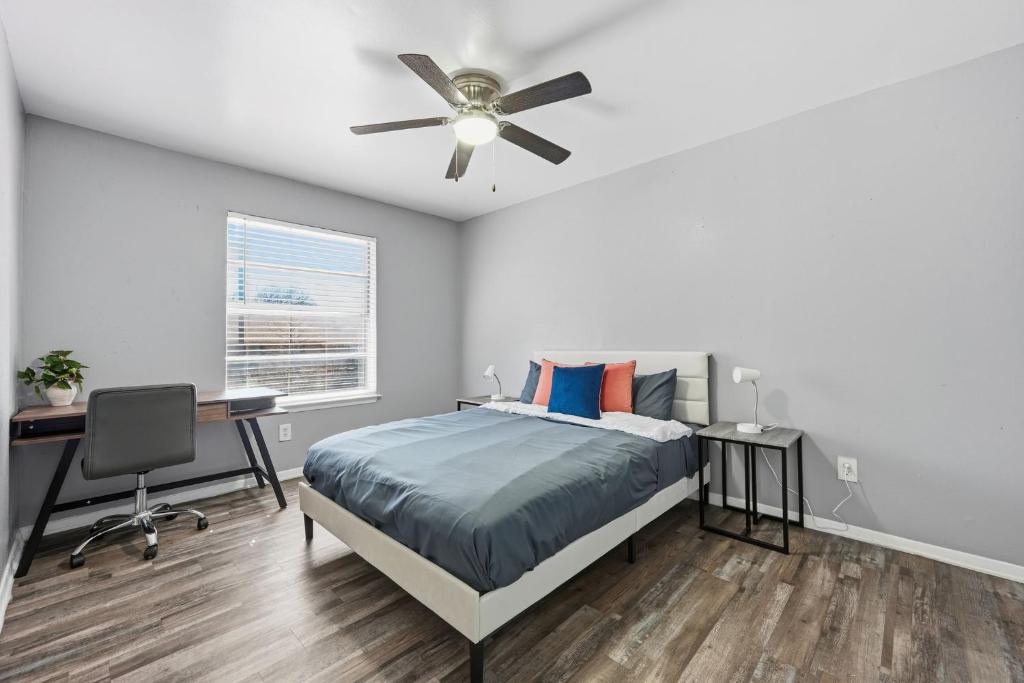 a bedroom with a bed and a ceiling fan at 2-bedroom with large living area in Denton