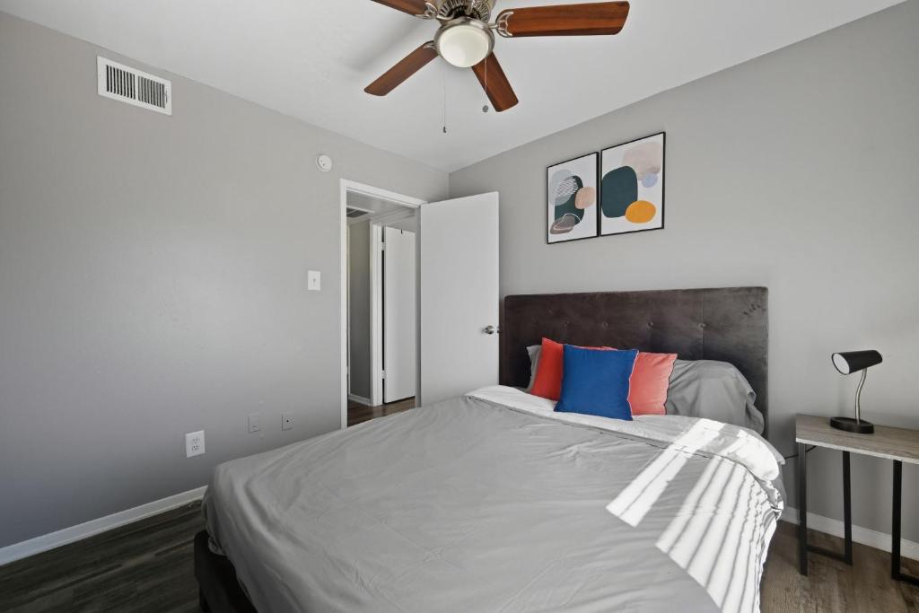 a bedroom with a bed with a ceiling fan at Denton pad with 2BR comfort in Denton