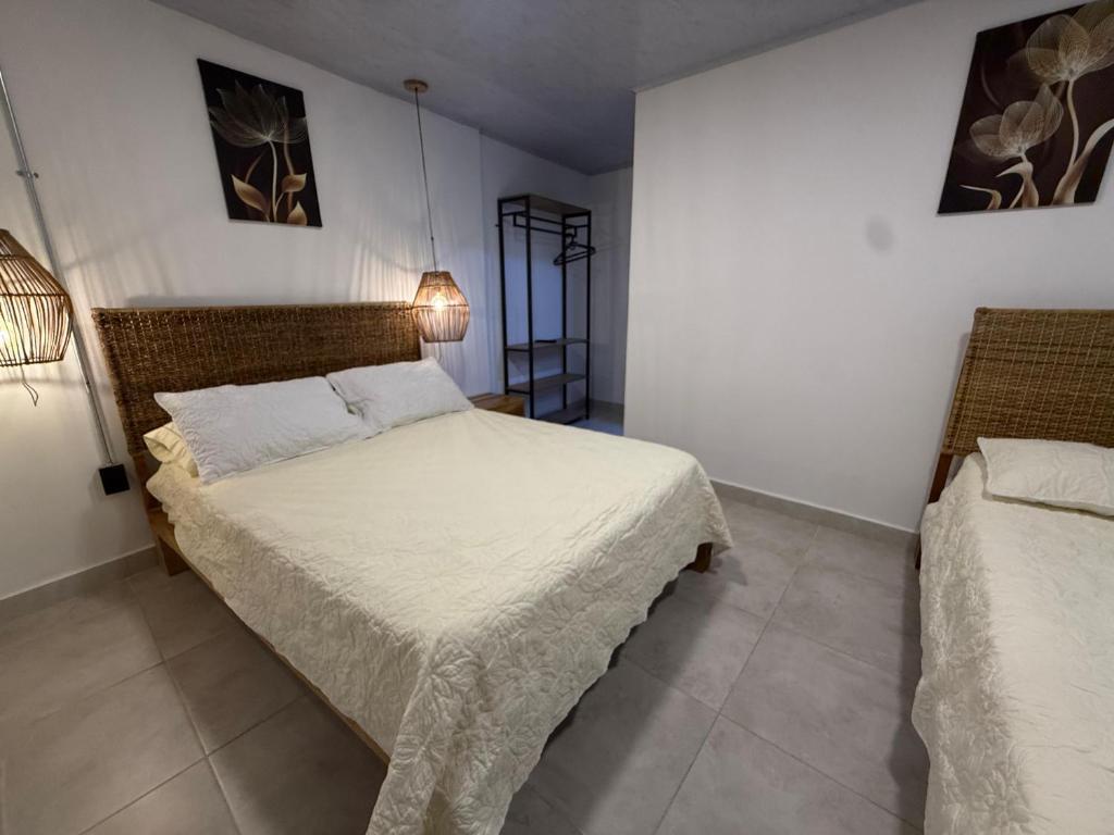 a bedroom with two beds in a room at Toba hotel boutique in Ibagué