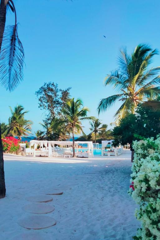 a view of a beach with palm trees at Lady D House Watamu in Watamu