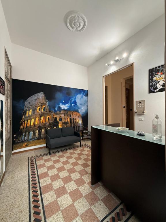 a living room with a large painting of a building at GUEST HOUSE BOSCO in Palermo