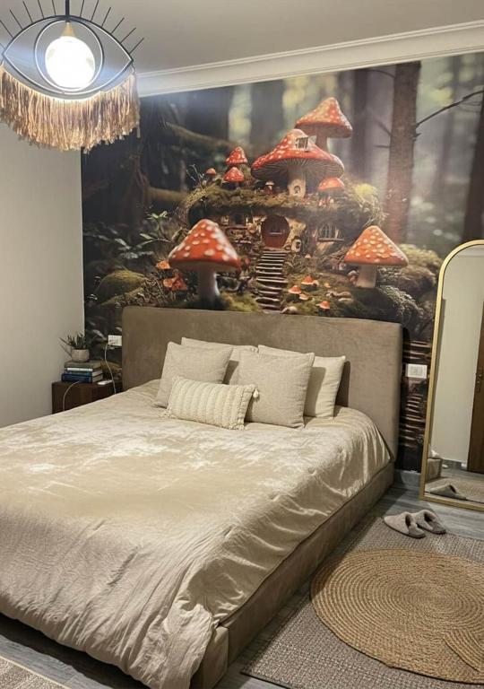 a bedroom with a bed with a painting on the wall at Sun capital stylish apartment in ‘Ezbet `Abd el-Ḥamîd