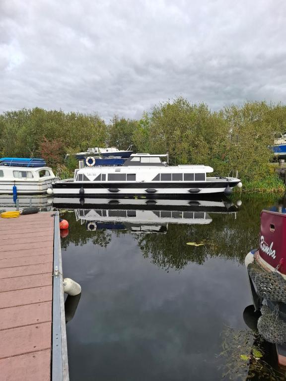 two boats are docked at a dock on the water at Hidden gem in Invernisk