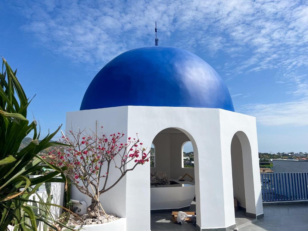 a building with a blue dome on top of it at Santonita Hotel & Tours in Ninh Hải