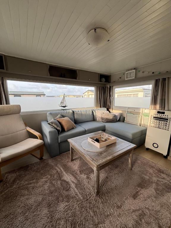 a living room with a couch and a coffee table at Blue Sea Horizon in Wenduine