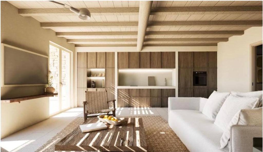 a living room with a white couch and a table at Villa AELIA by LLB Mykonos - 2BDR - Sea & Sunset view in Mikonos