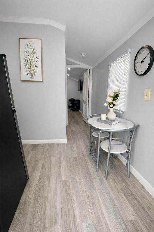 a dining room with a table and a clock on the wall at Beautiful independent suite in Brandon