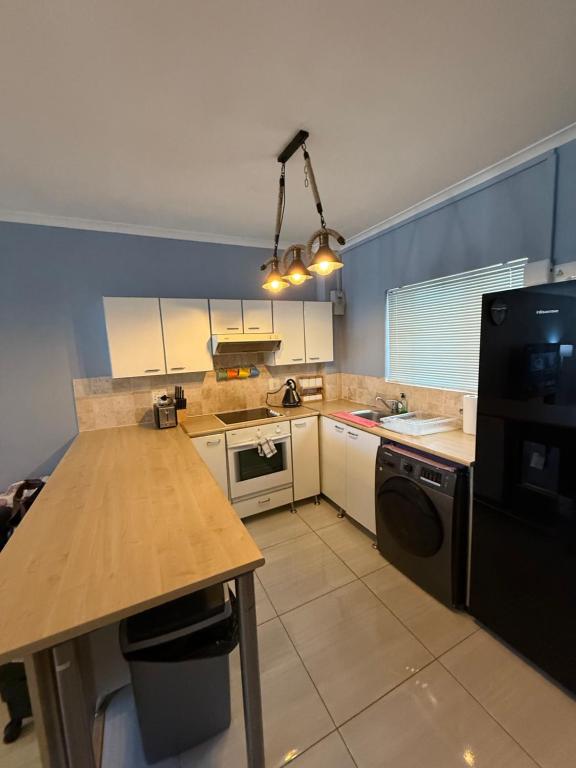 a kitchen with a sink and a counter top at Cozy Apartment with Table Mountain and beach views in Cape Town