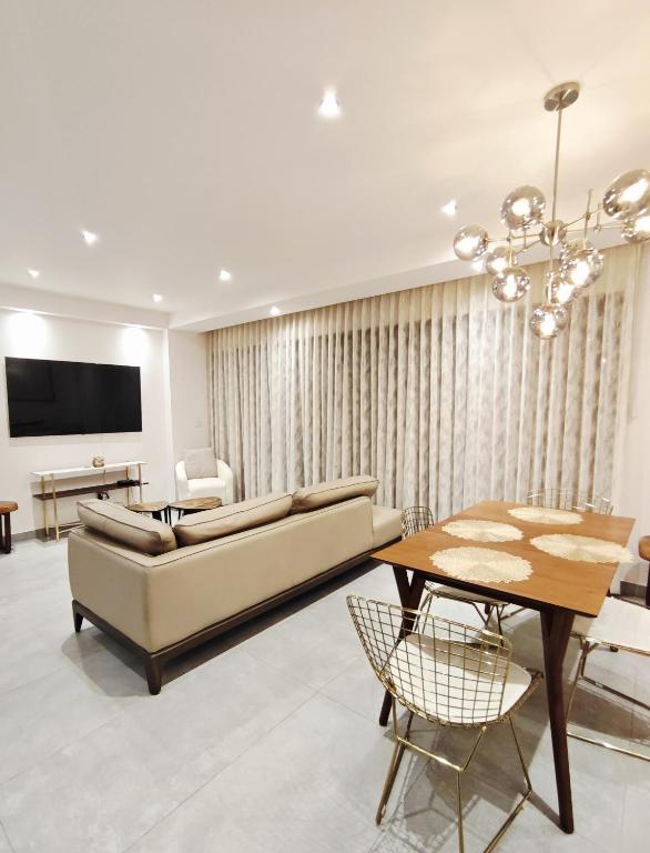 a living room with a couch and a table at Luxury Condo Residencial Area Close to Everything in Puerto Vallarta