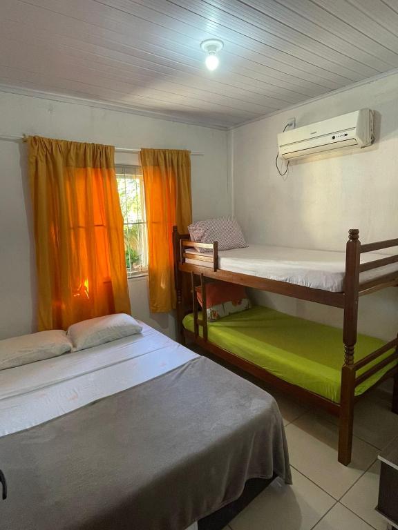a room with two bunk beds and a window at Barra in Barra Velha