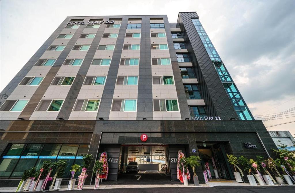 a tall building with a sign in front of it at Daegu Innovation City Stay22 in Panyawŏl-yŏk