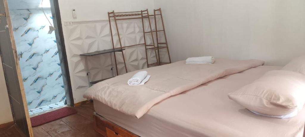 a room with a bed with a mirror and a fish tank at Djambu Tree Homestay in Biha
