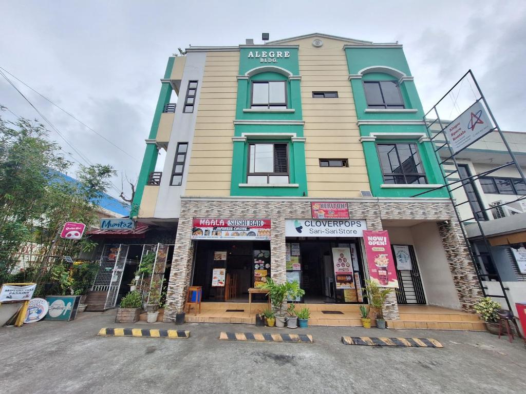a store front of a building on a street at Alegre Building Lipa in Lipa