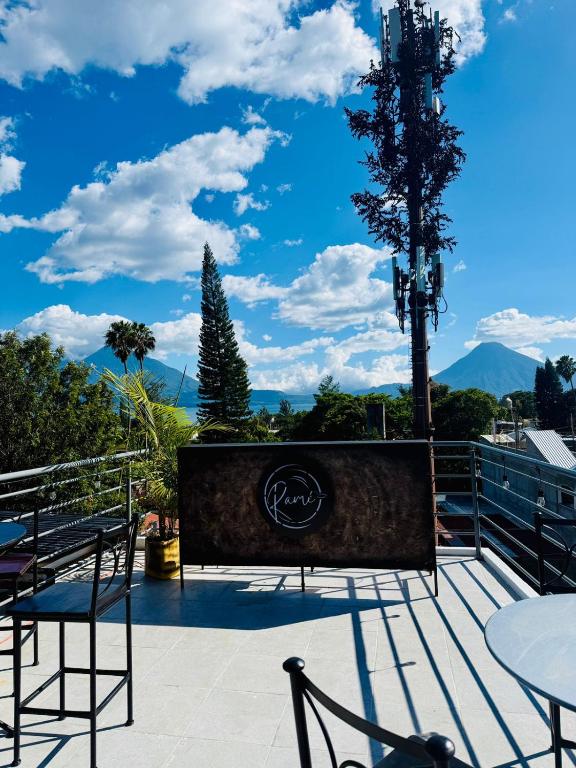 a patio with a table and chairs and a tree at Apartamento Stay and Chill in Panajachel
