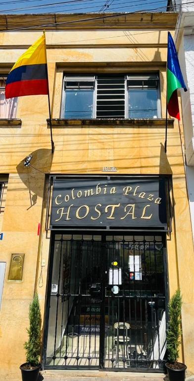 a store front with a flag and a sign on a building at Hostal Colombia plaza in San Gil