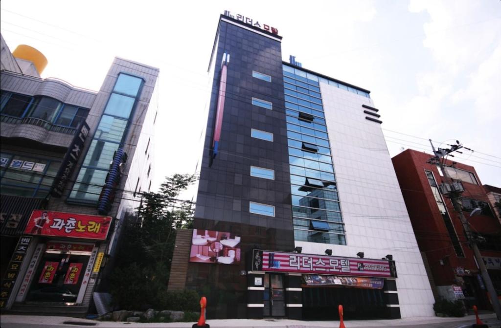 a tall building in the middle of a city at Dongdaegu Leaders Hotel in Daegu