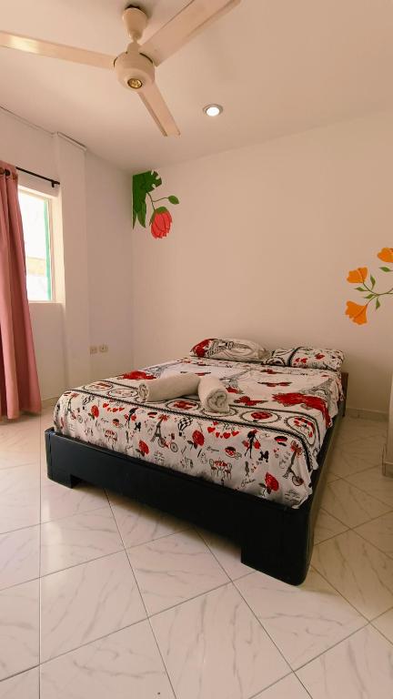 a bed sitting in a room with at frente al mar Hotel La Morena in Taganga