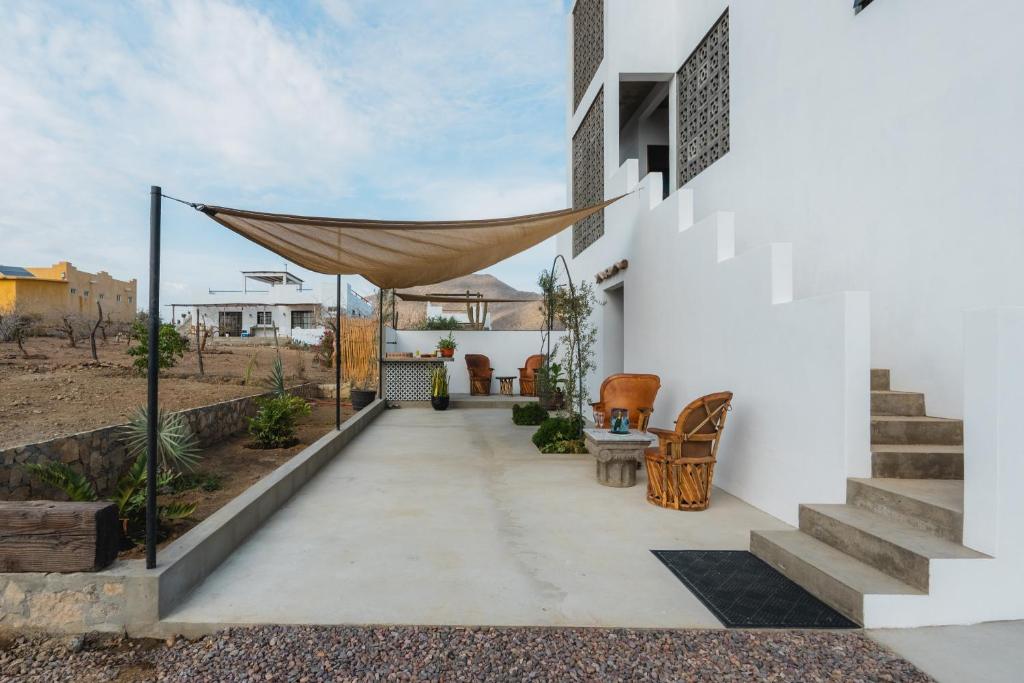 a patio with a hammock on the side of a house at Olivo in San Carlos