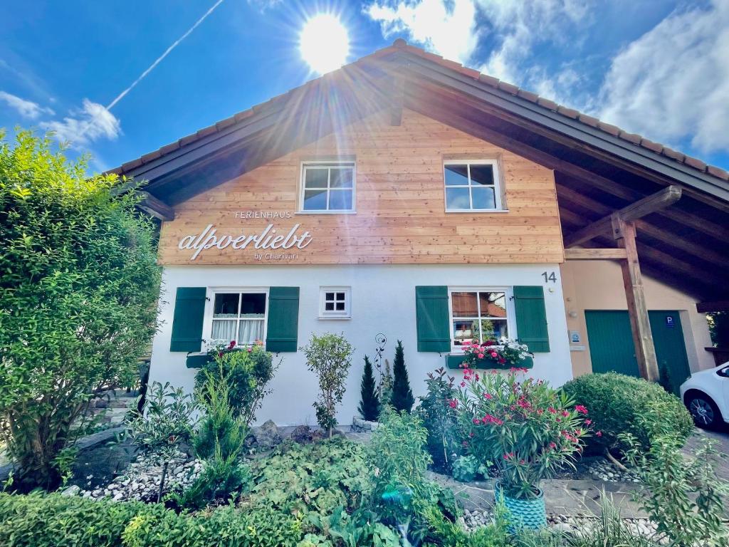 a building with a sign on the side of it at Ferienhaus ALPVERLIEBT Sommer-Hörnerbahnen kostenlos in Bolsterlang