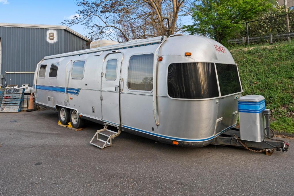 a silver trailer is parked in a parking lot at Airstream in Art's District in Asheville