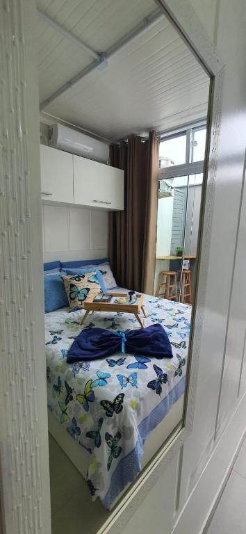 a mirror reflection of a bed in a bedroom at Blessed Homes in Braço do Norte