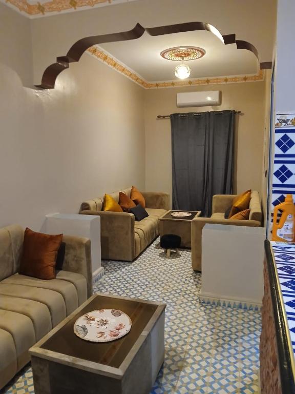 a living room with couches and a table at Casa Ayour in Merzouga