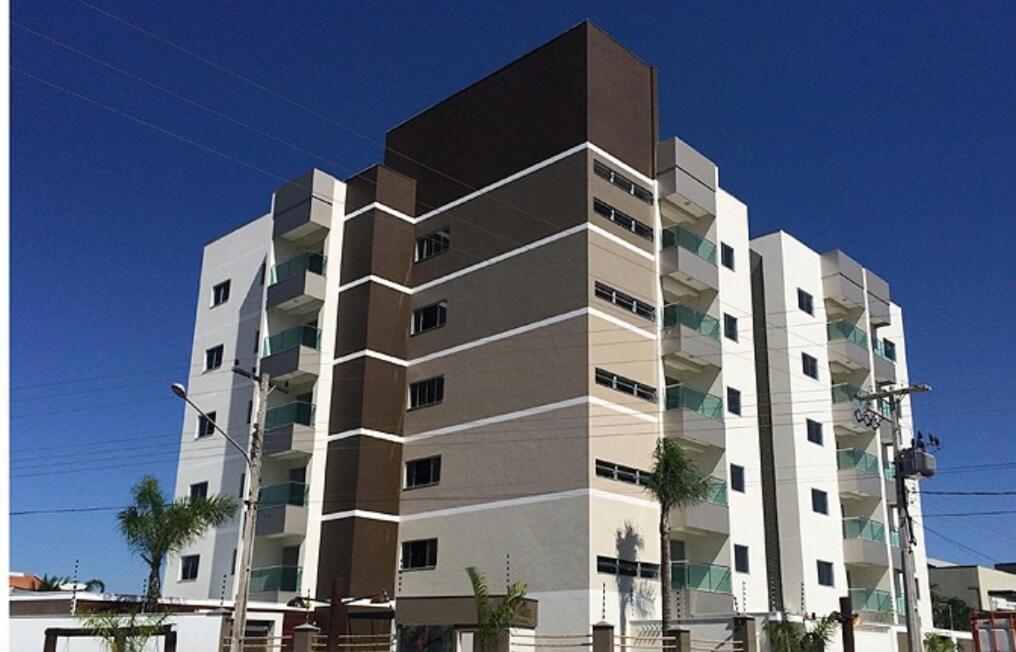 a tall white building with a black top at Downtown apartment in Sinop