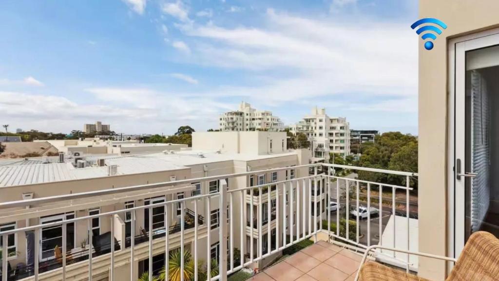 a balcony with a view of the city at Stylish Apartment in Melbourne
