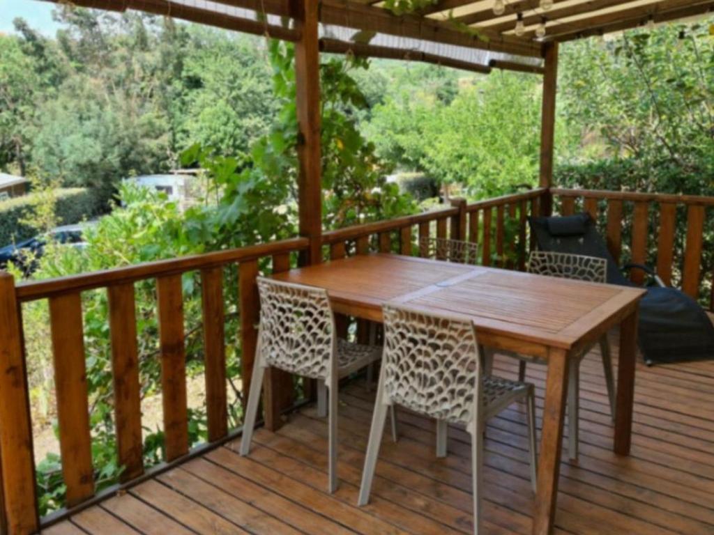 a wooden table and chairs on a deck at Chalet 4 Pers - Terrasse - API-1-52-1751 in Espira-de-Conflent