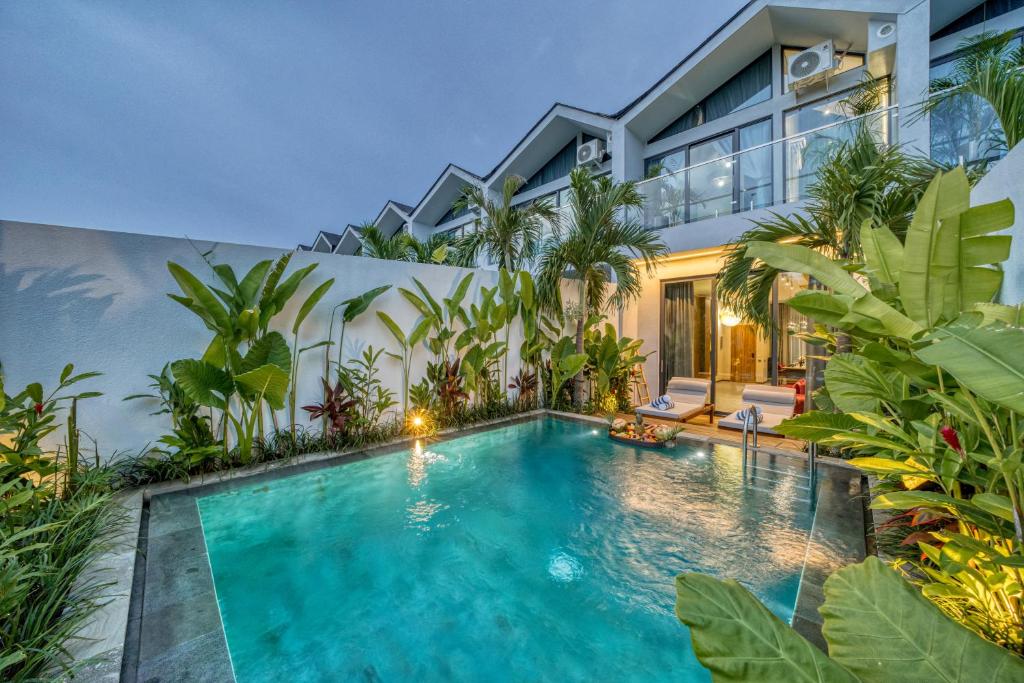 a swimming pool in front of a house at Melasti Dream Residence in Uluwatu