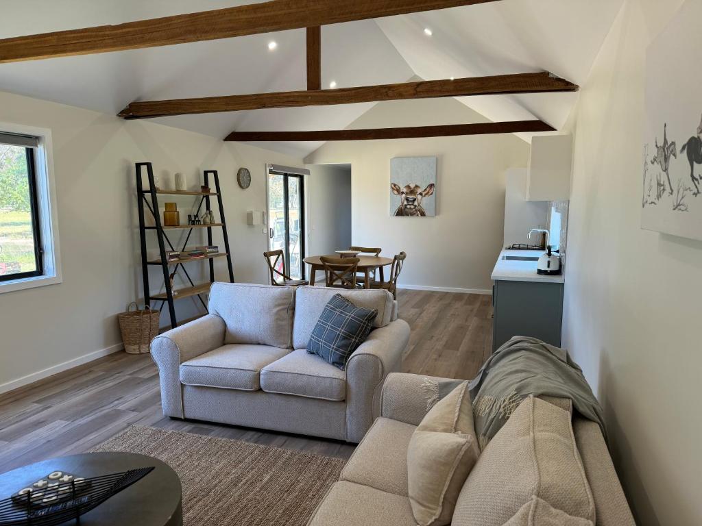a living room with a couch and a table at The Grain Shed in Euroa