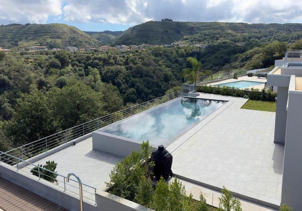 a swimming pool on the roof of a house at Luxury Villa in Calabria in Gasponi