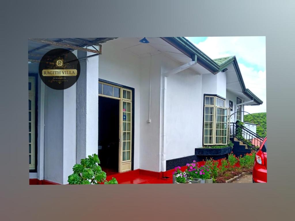 a white building with a sign on the side of it at Ragith Villa in Nuwara Eliya