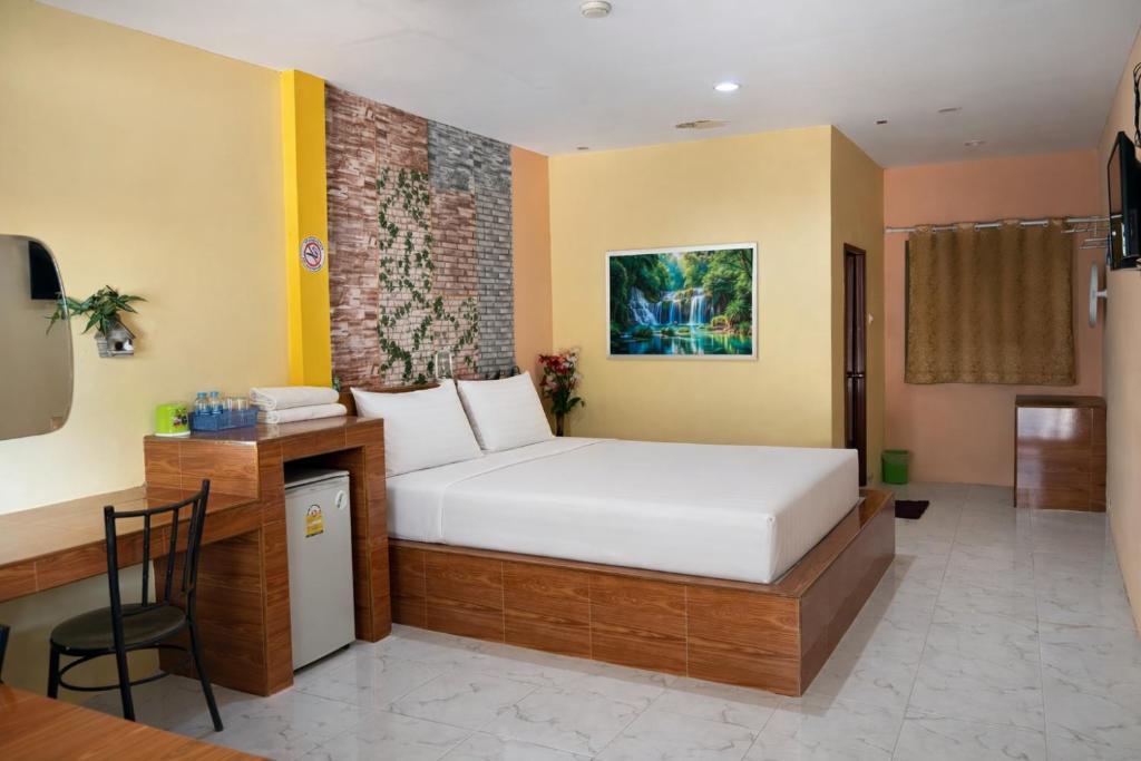 a bedroom with a bed and a desk in it at FHR Krabi City Hotel in Krabi