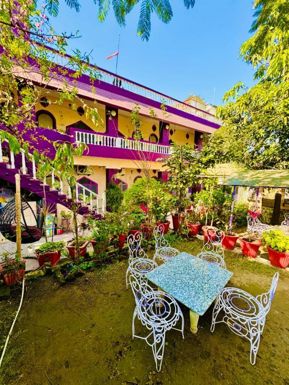 a table and chairs in front of a building at Hotel New Sun and Rock in Mount Ābu