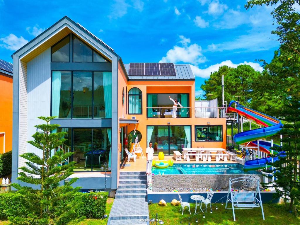 a house with a pool and a slide at MK Land Pool Villa Khaokho in Khao Kho