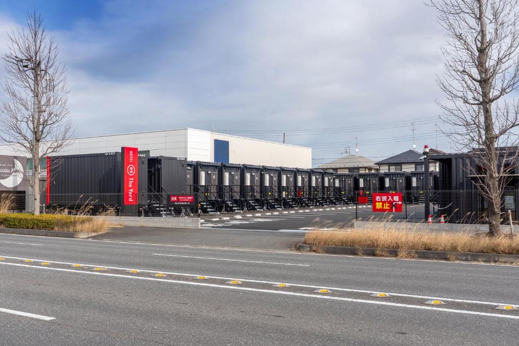 a train is parked on the side of a road at HOTEL R9 The Yard Ryugasaki in Shōjiki
